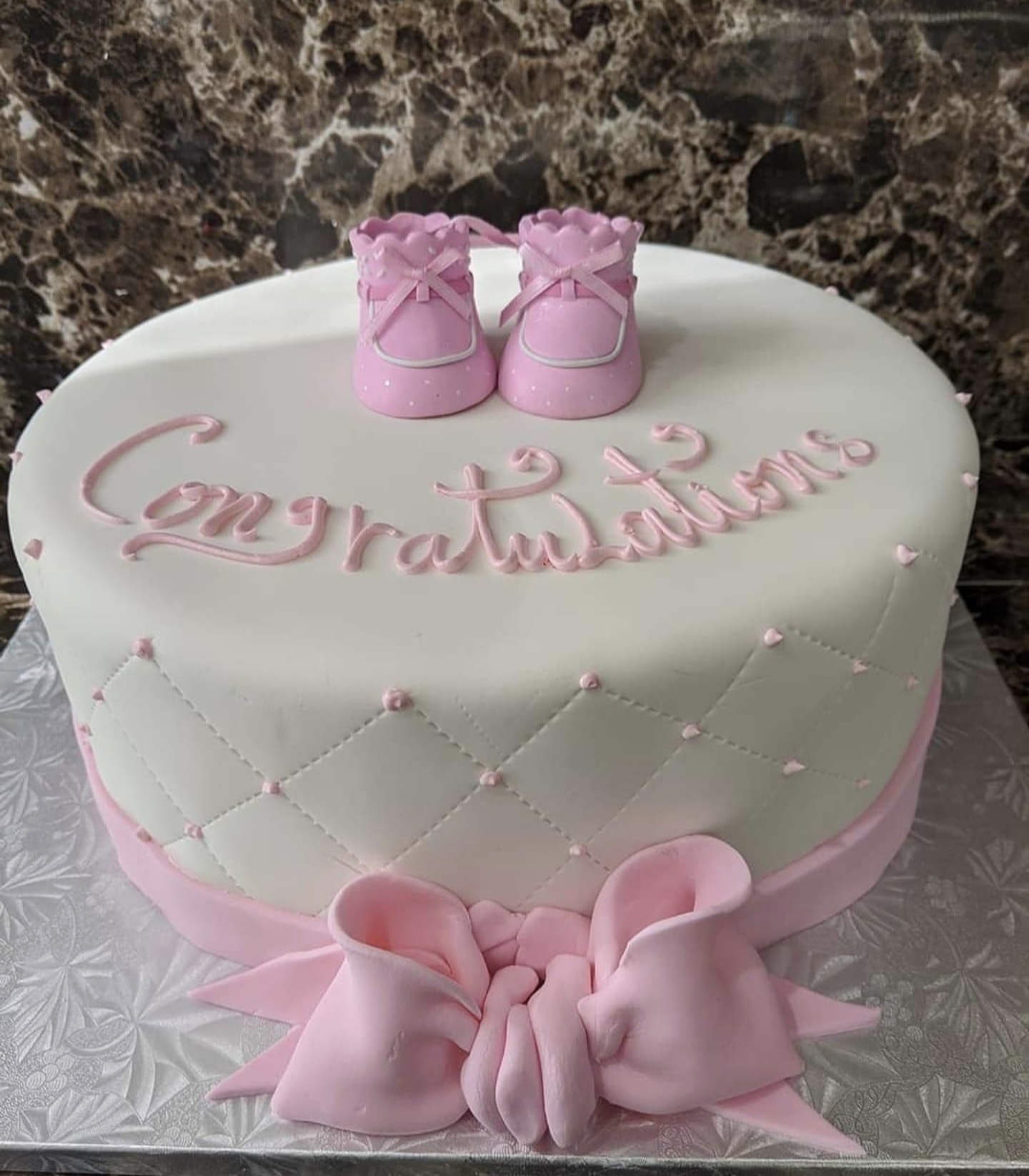 Baby shower cake with fondant booties decoration